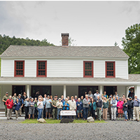 Group photo in front of MacNaughton Cottage at Adirondack Upper Works